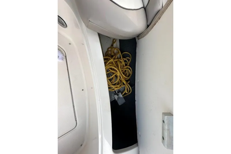 Slide: The Image of Storage compartment with yellow rope on a 2004 Sea Ray 270 Sundeck boat. - 40