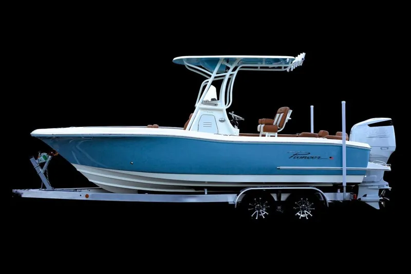 The Image of 2026 Pioneer 222 Sportfish boat on trailer, blue hull, white trim, side view. - 0