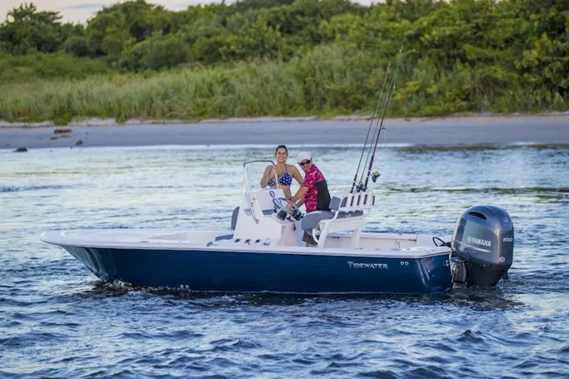 The Image of 2026 Tidewater 2110 Bay Max boat on water, featuring Yamaha engine, with two people onboard. - 1