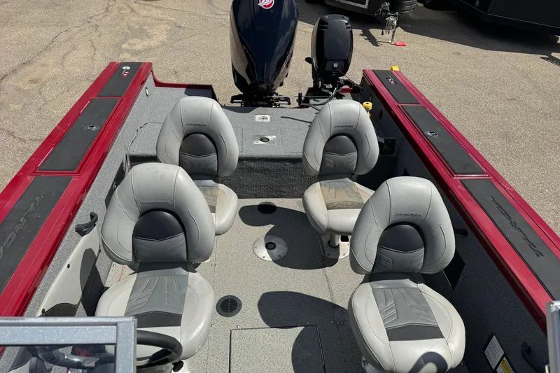 Slide: The Image of 2019 Tracker Targa V-18 WT boat interior with four gray seats and red accents. - 10