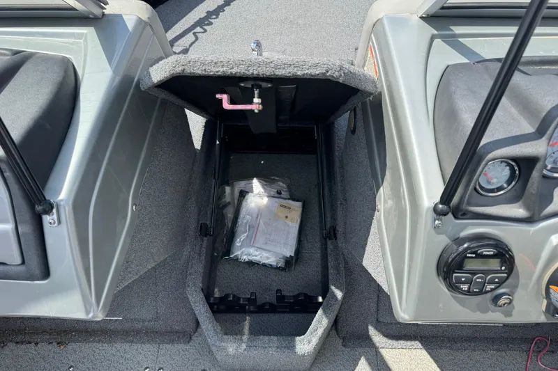 Slide: The Image of Open storage compartment in 2019 Tracker Targa V-18 WT boat, showing interior contents. - 14