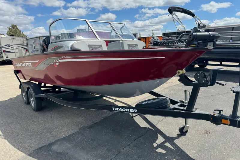Slide: The Image of 2019 Tracker Targa V-18 WT boat on trailer under a blue sky. - 2