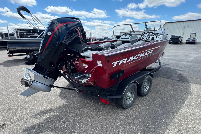 Slide: The Image of 2019 Tracker Targa V-18 WT boat on trailer, parked outdoors under a cloudy sky. - 3