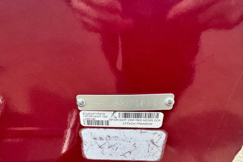 Slide: The Image of 2019 Tracker Targa V-18 WT boat identification plate on red surface. - 5