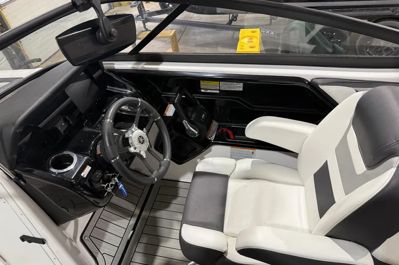 Slide: The Image of 2021 Yamaha Boats 212S cockpit with steering wheel and captain's seat. - 3
