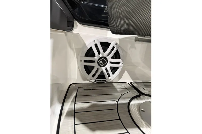 Slide: The Image of 2021 Yamaha Boats 212S interior with Rockford Fosgate speaker and sleek flooring design. - 7