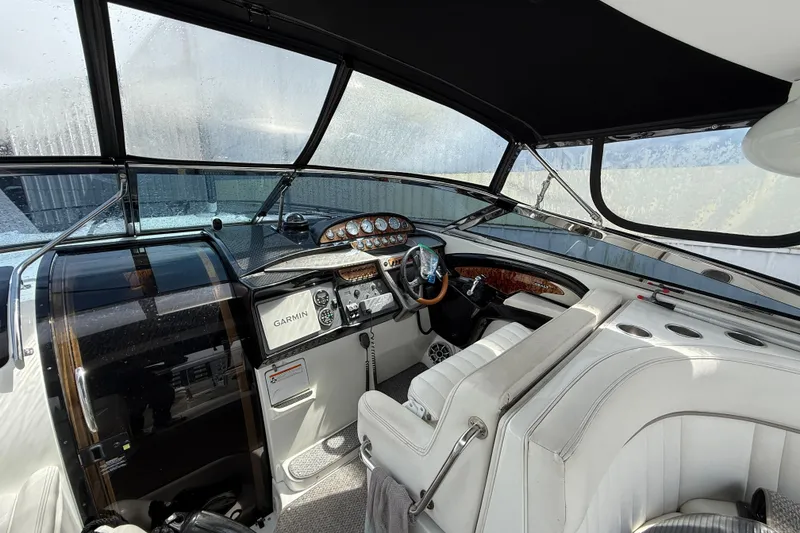 Slide: The Image of Interior of a 2004 Cobalt 360 boat with modern dashboard and steering wheel. - 10
