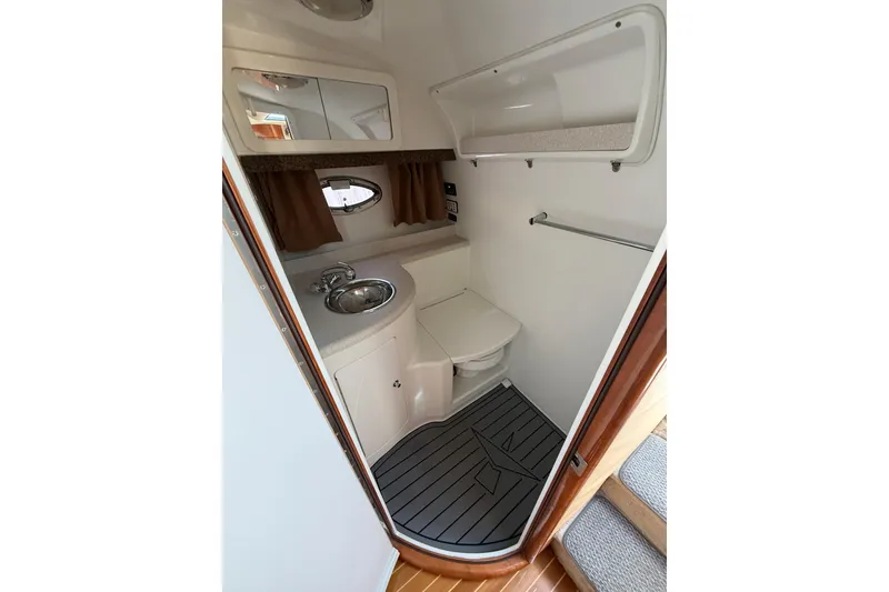 Slide: The Image of Compact bathroom in 2004 Cobalt 360 boat with sink, toilet, and mirror. - 11