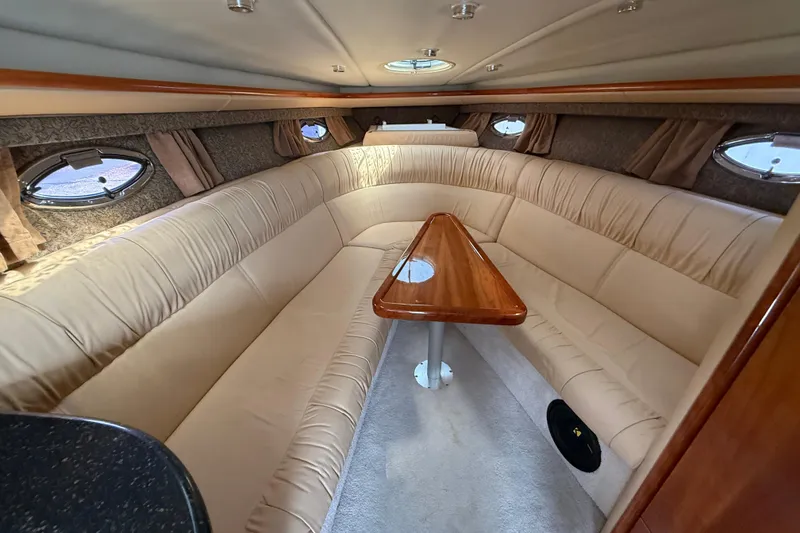 Slide: The Image of Luxurious interior of a 2004 Cobalt 360 boat with plush seating and elegant wood table. - 12