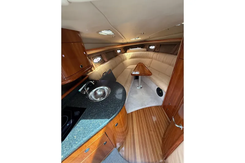 Slide: The Image of Luxurious interior of a 2004 Cobalt 360 yacht with wood finishes and cozy seating. - 17
