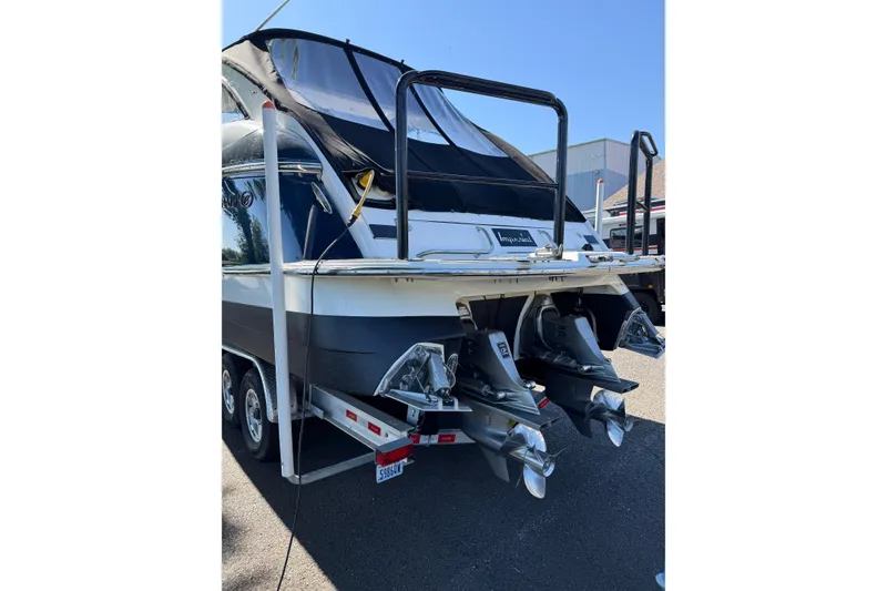 Slide: The Image of 2004 Cobalt 360 boat on trailer, rear view showing dual propellers and sleek design. - 22