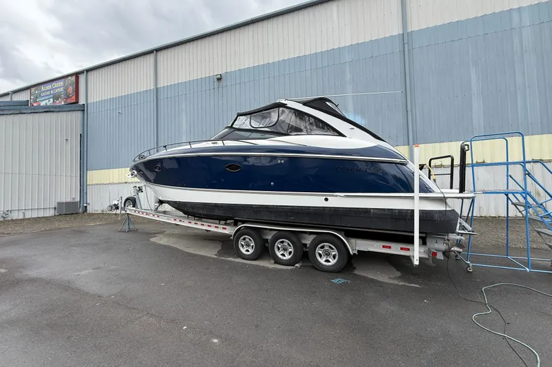 Slide: The Image of 2004 Cobalt 360 boat on trailer outside a warehouse, ready for transport. - 3