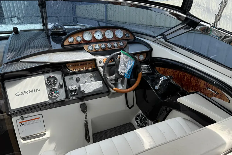 Slide: The Image of Cockpit of a 2004 Cobalt 360 boat featuring Garmin navigation and wood accents. - 7