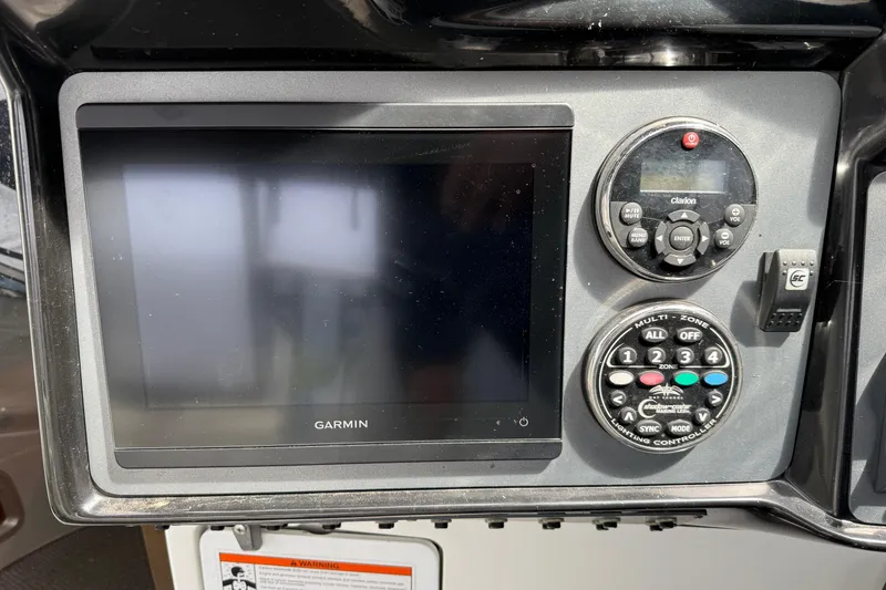 Slide: The Image of Garmin display and controls on a 2004 Cobalt 360 boat dashboard. - 8
