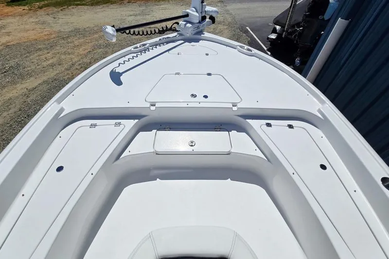 Slide: The Image of 2026 Tidewater 2210 Carolina Bay boat deck with storage compartments and trolling motor. - 14