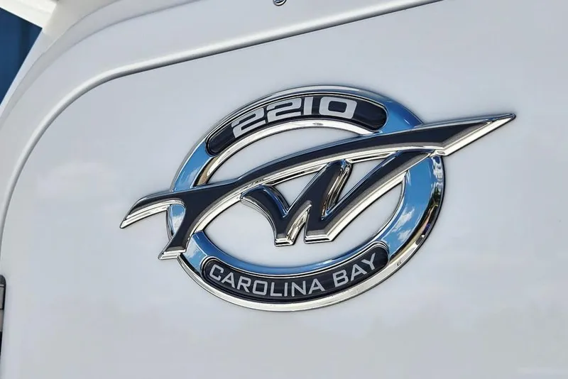 Slide: The Image of Chrome emblem of 2026 Tidewater 2210 Carolina Bay boat on white surface. - 18
