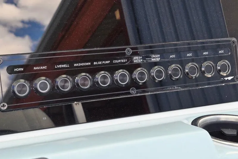 Slide: The Image of Control panel of 2026 Tidewater 2210 Carolina Bay boat with labeled switches. - 23