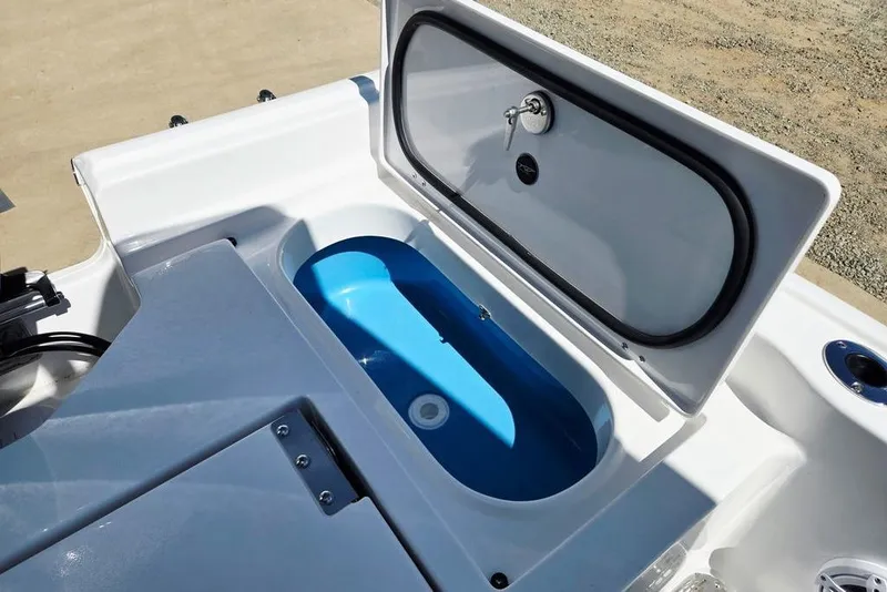 Slide: The Image of Livewell compartment on 2026 Tidewater 2210 Carolina Bay boat, open lid, blue interior. - 27