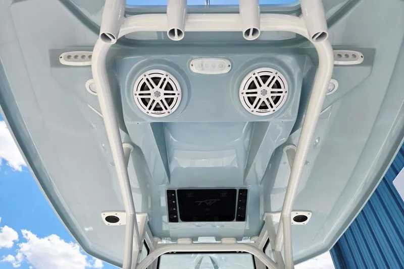 Slide: The Image of Tidewater 2210 Carolina Bay 2026 boat interior with speakers and rod holders. - 29