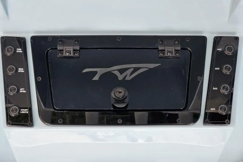 Slide: The Image of Control panel of 2026 Tidewater 2210 Carolina Bay boat with switches and logo. - 32