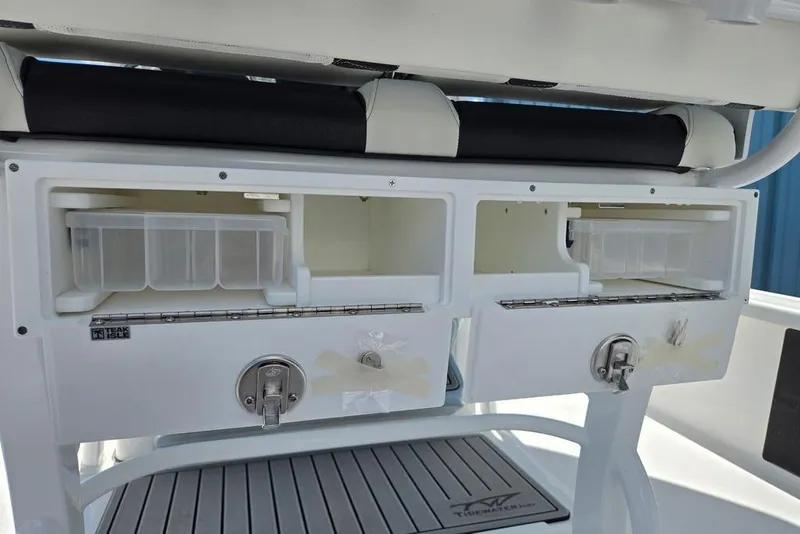 Slide: The Image of Storage compartments on a 2026 Tidewater 2210 Carolina Bay boat, featuring secure latches and organized space. - 35