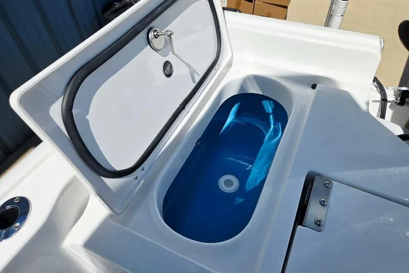 Slide: The Image of 2026 Tidewater 2210 Carolina Bay boat with open storage compartment, featuring a blue interior. - 36