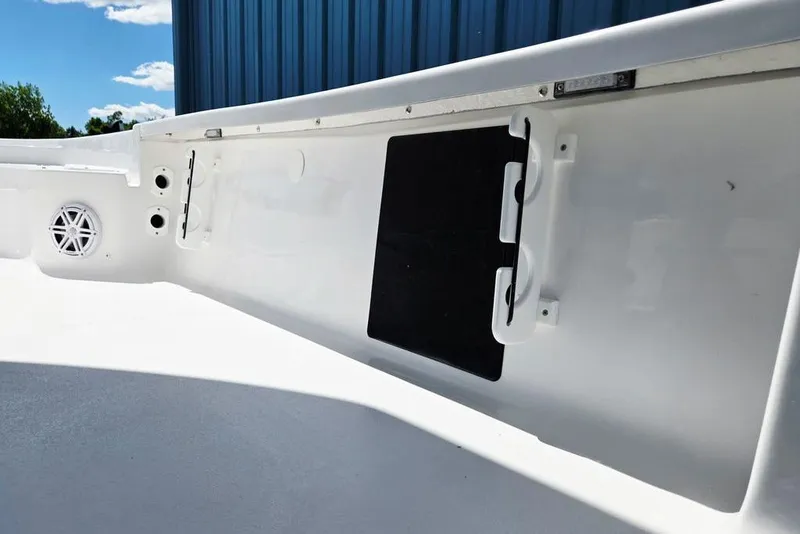Slide: The Image of 2026 Tidewater 2210 Carolina Bay boat interior with speaker and storage compartment. - 41