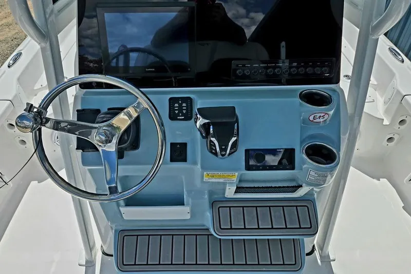 Slide: The Image of 2026 Tidewater 2210 Carolina Bay boat console with steering wheel and controls. - 47