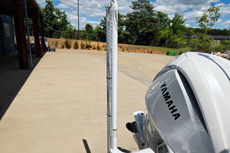 Slide: The Image of 2026 Tidewater 2210 Carolina Bay with Yamaha engine, parked outdoors under blue sky. - 51