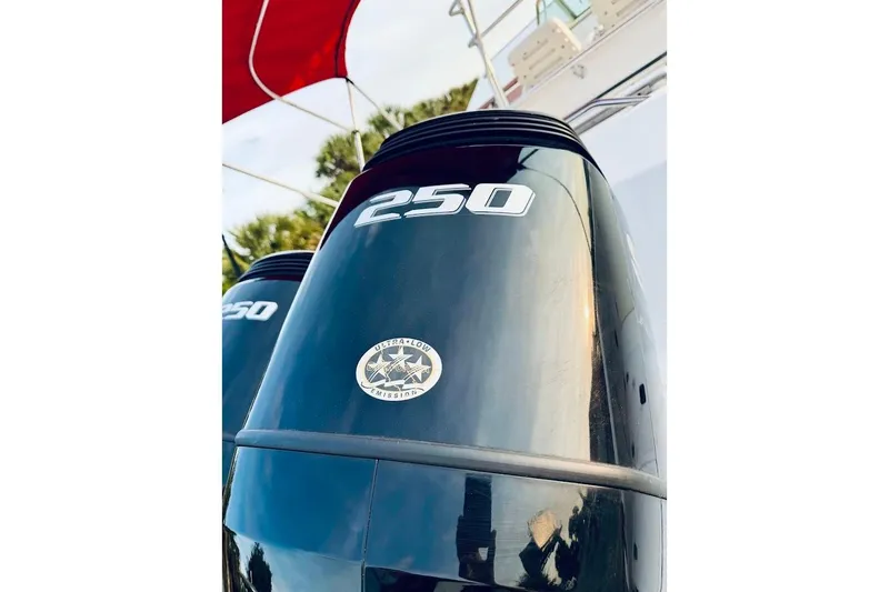 Slide: The Image of Outboard motor on a 2002 Boston Whaler 290 Outrage, featuring "250" label and low emissions badge. - 14