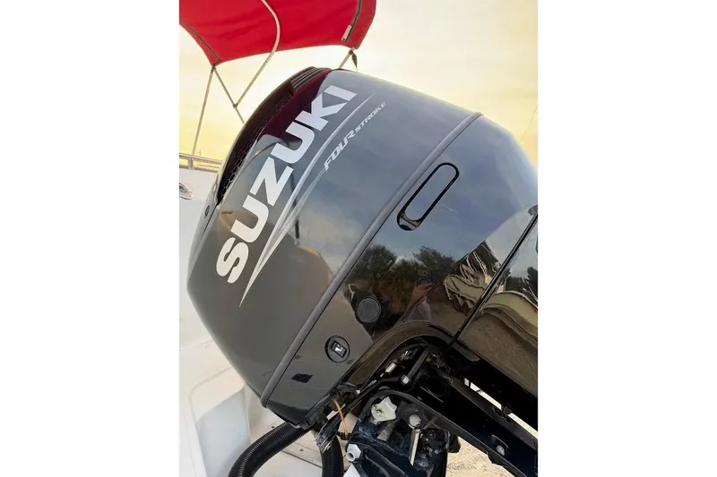 Slide: The Image of Suzuki outboard motor on 2002 Boston Whaler 290 Outrage boat with red canopy. - 19
