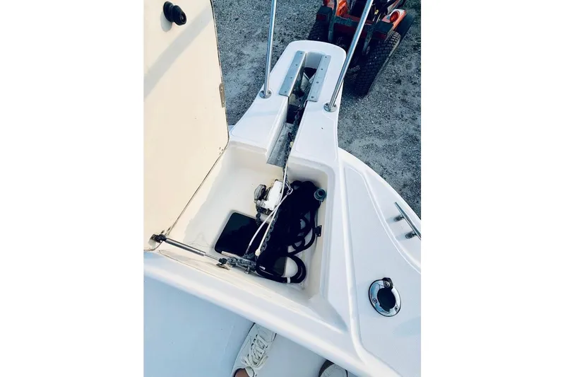 Slide: The Image of Open storage compartment on a 2002 Boston Whaler 290 Outrage boat, showing equipment and accessories. - 37