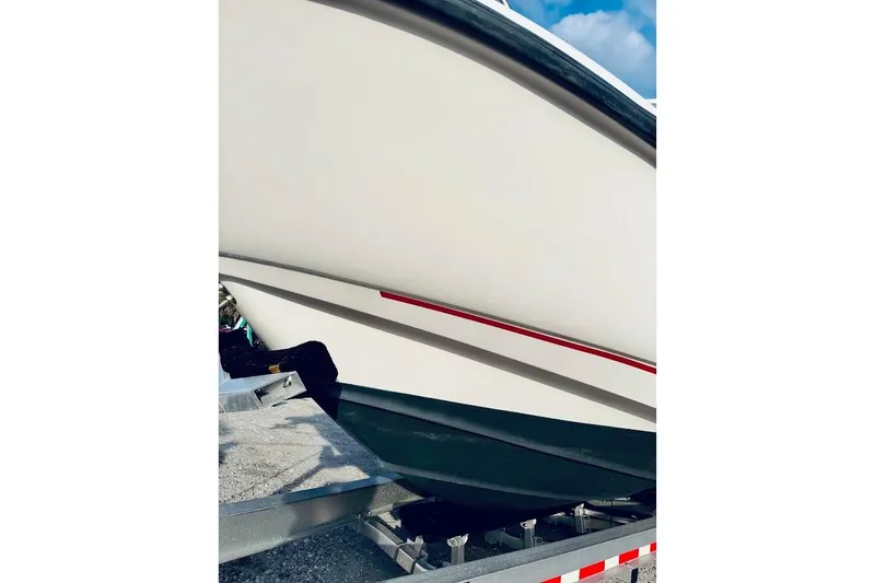 Slide: The Image of 2002 Boston Whaler 290 Outrage boat hull on trailer, close-up view. - 4