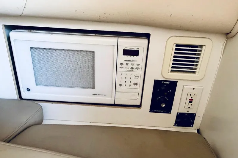 Slide: The Image of Built-in microwave and control panel on a 2002 Boston Whaler 290 Outrage boat. - 41