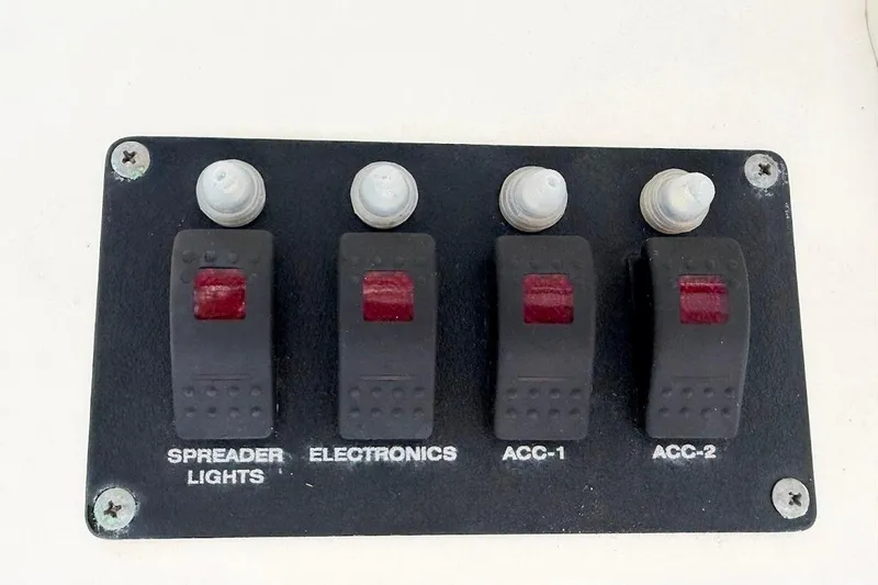 Slide: The Image of Control panel with switches for spreader lights and electronics on a 2002 Boston Whaler 290 Outrage. - 48