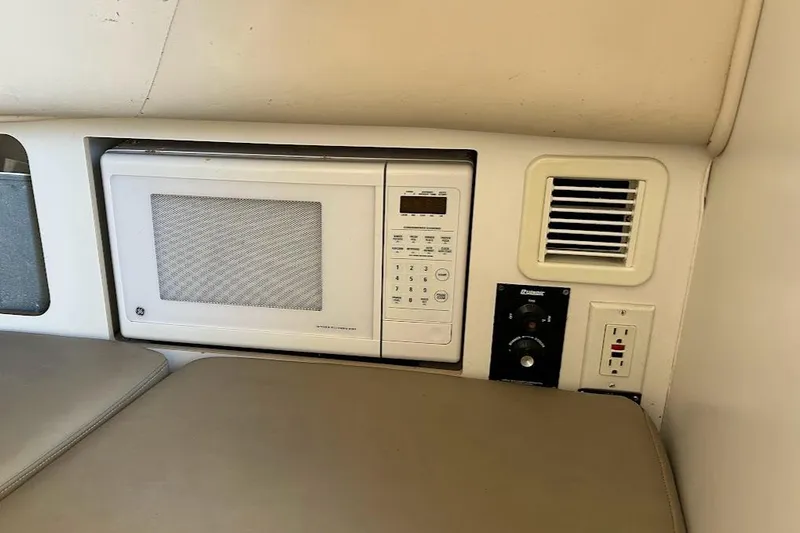 Slide: The Image of Interior of a 2002 Boston Whaler 290 Outrage featuring a built-in microwave. - 56