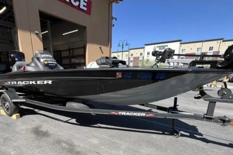 The Image of 2022 Tracker Pro Team 190 TX boat on trailer outside a building. - 0