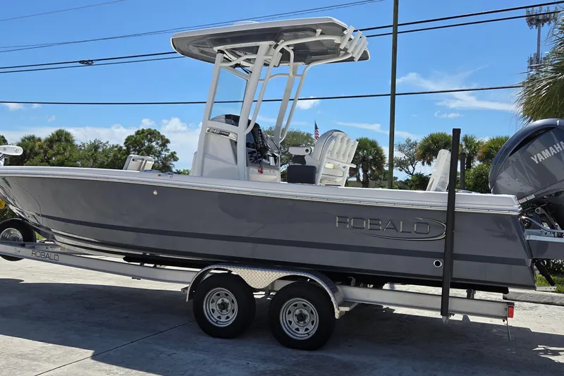 The Image of 2024 Robalo 246 Cayman boat on trailer, side view, outdoors, sunny day. - 0