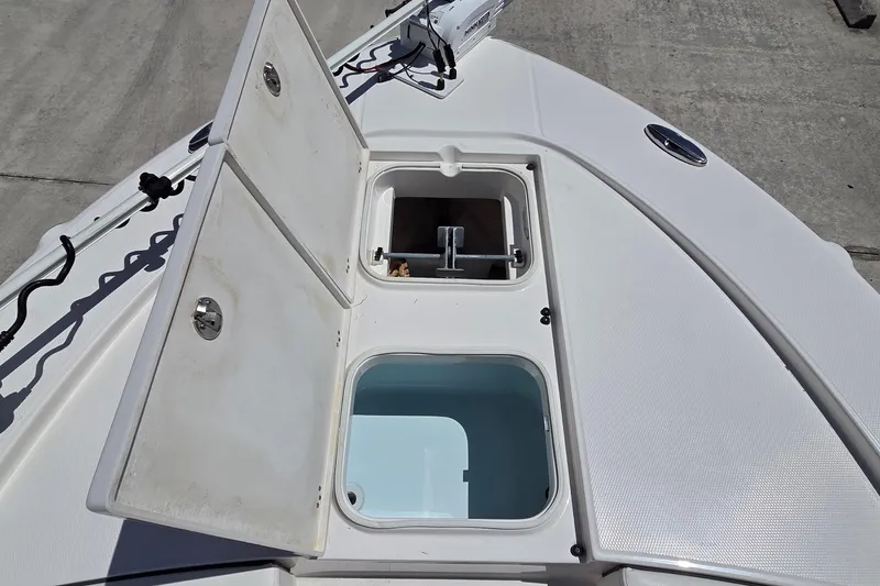 Slide: The Image of 2024 Robalo 246 Cayman boat deck with open storage compartments. - 12