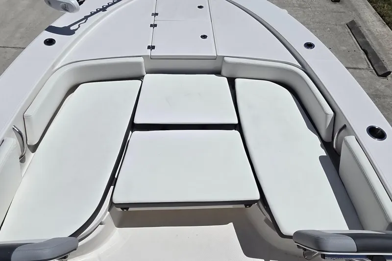 Slide: The Image of 2024 Robalo 246 Cayman boat interior with cushioned seating and storage compartments. - 14