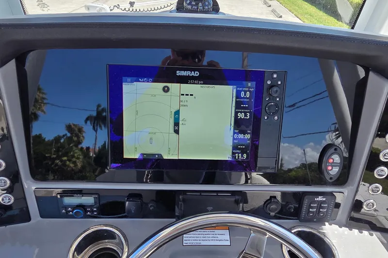 Slide: The Image of 2024 Robalo 246 Cayman boat dashboard with Simrad navigation display. - 17