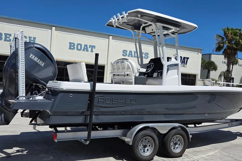 Slide: The Image of 2024 Robalo 246 Cayman boat with Yamaha engine on trailer at dealership. - 18