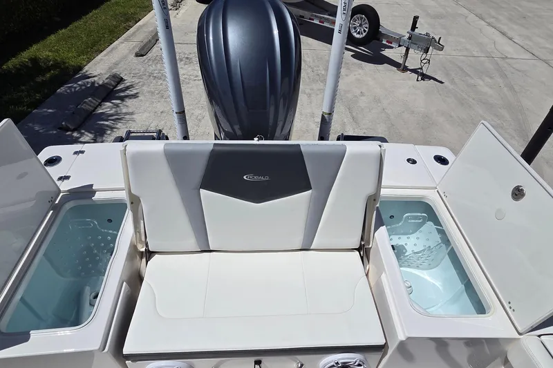 Slide: The Image of 2024 Robalo 246 Cayman boat with open storage compartments and seating. - 7