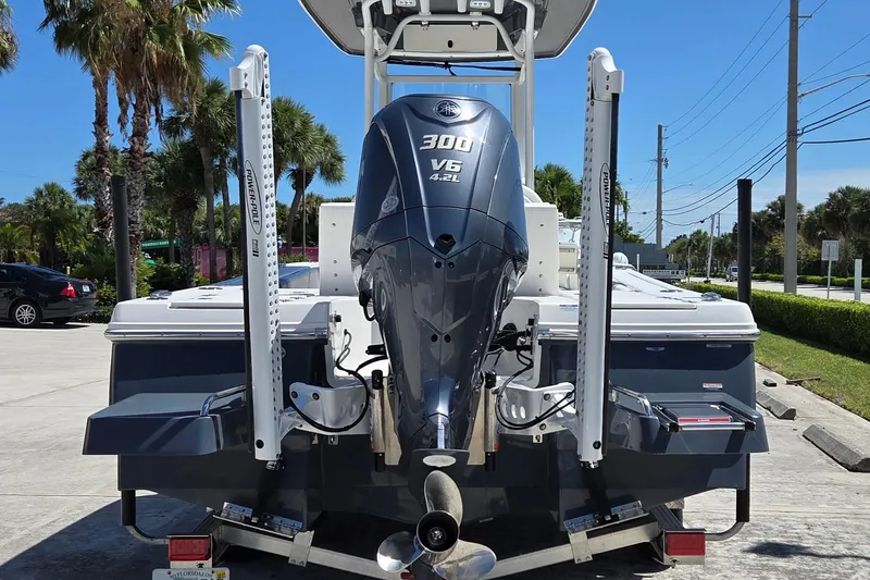 Slide: The Image of 2024 Robalo 246 Cayman boat with Yamaha 300 V6 engine, parked outdoors. - 8
