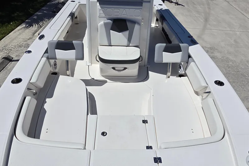 Slide: The Image of 2024 Robalo 246 Cayman boat interior with seating and storage compartments. - 9