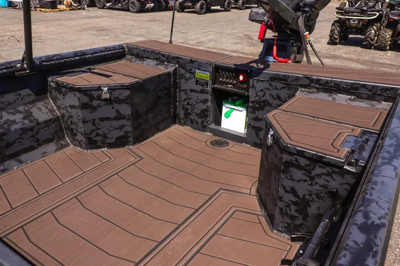 Slide: The Image of Interior of 2026 Gator Tail 18/60 Extreme Series boat with camo design and storage compartments. - 10