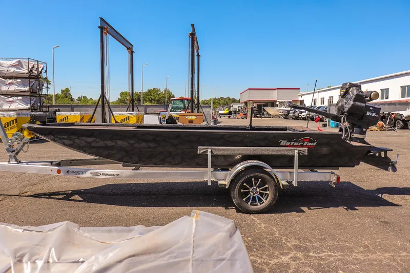 Slide: The Image of 2026 Gator Tail 18/60 Extreme Series boat on trailer in outdoor setting. - 8