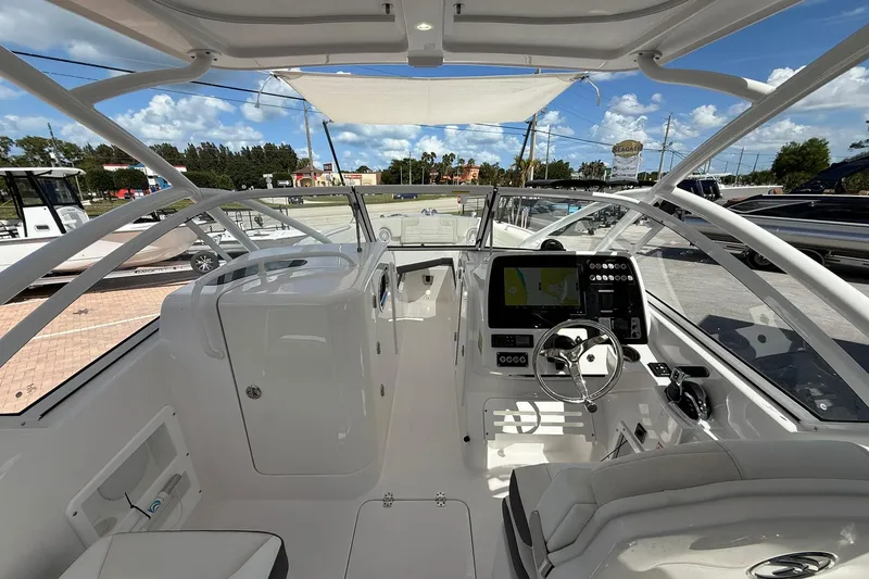 Slide: The Image of Interior view of 2026 Edgewater 248CX Crossover boat, featuring modern dashboard and seating. - 16