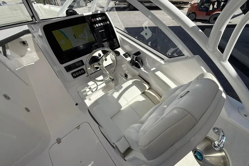 Slide: The Image of Interior of 2026 Edgewater 248CX Crossover boat with modern dashboard and steering wheel. - 17