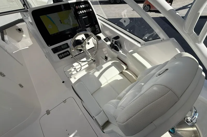 Slide: The Image of 2026 Edgewater 248CX Crossover boat cockpit with modern steering and navigation system. - 18